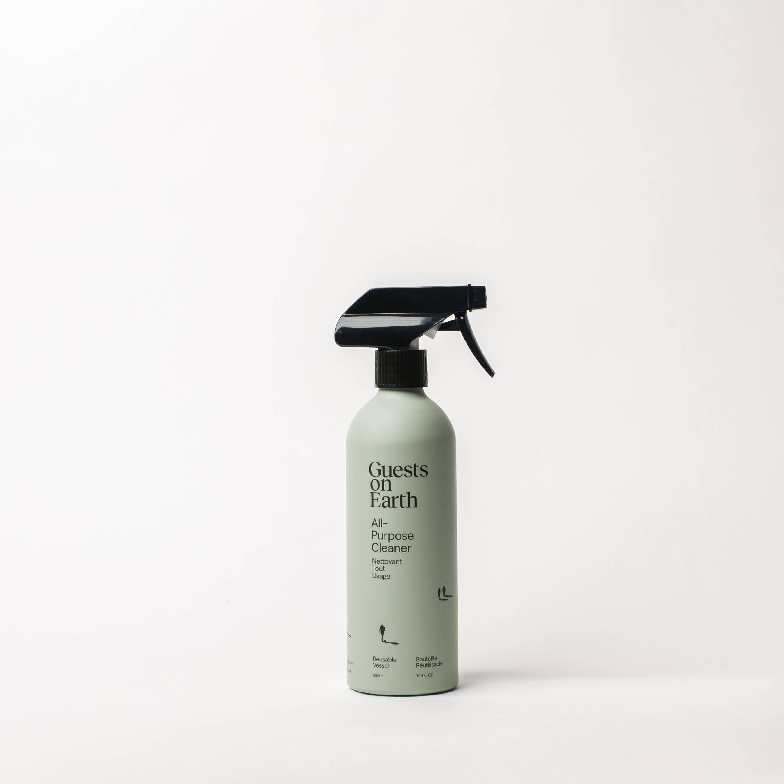 Spray bottle labeled 'Guests on Earth' on a white background