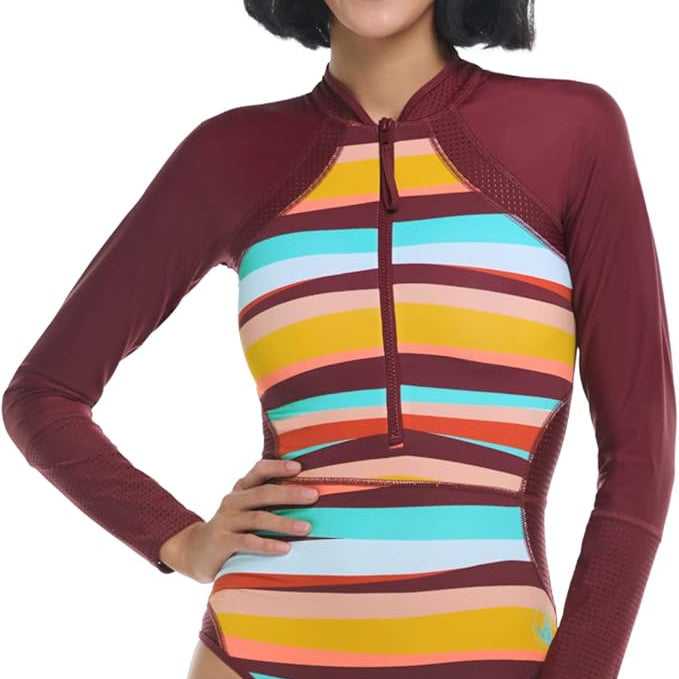 Woman wearing a colorful striped swimsuit with a maroon hood on a white background