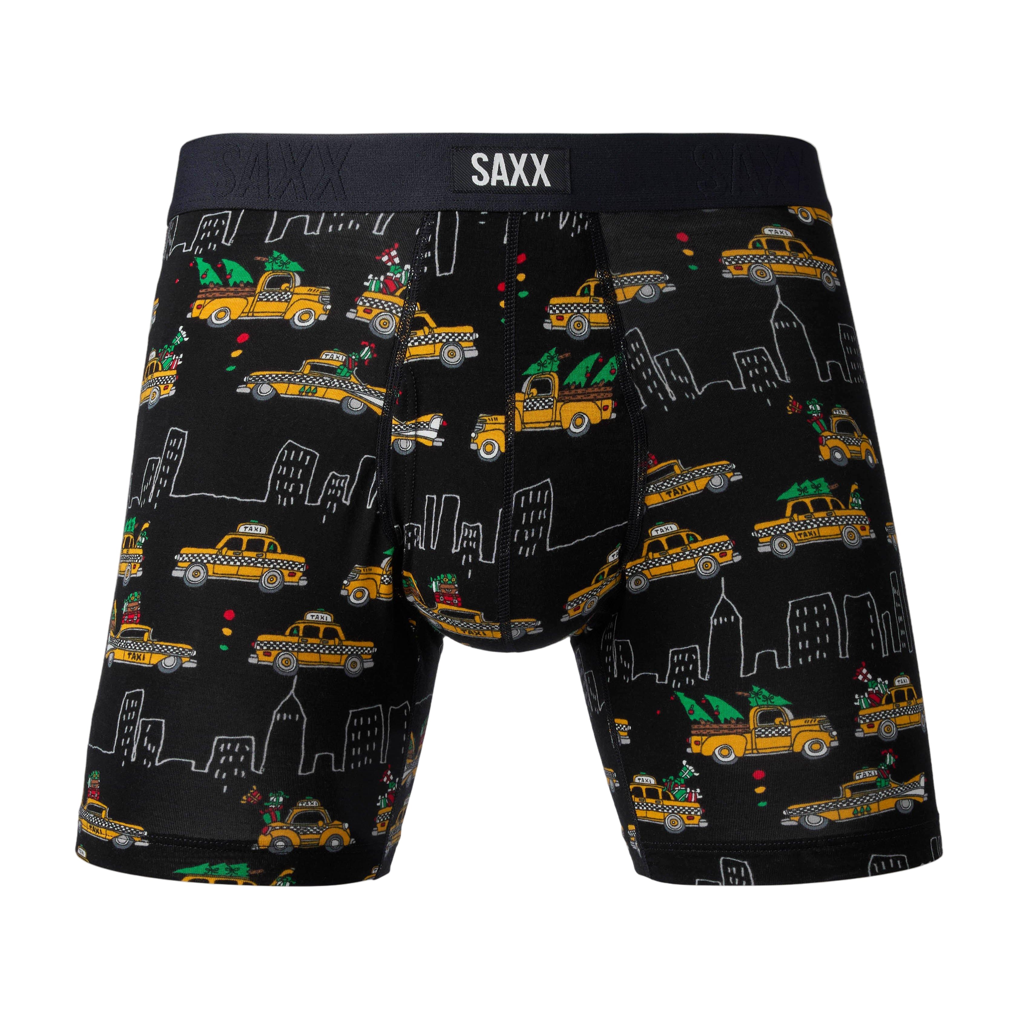 Black boxer briefs with taxi and cityscape pattern and SAXX branding on a gray background