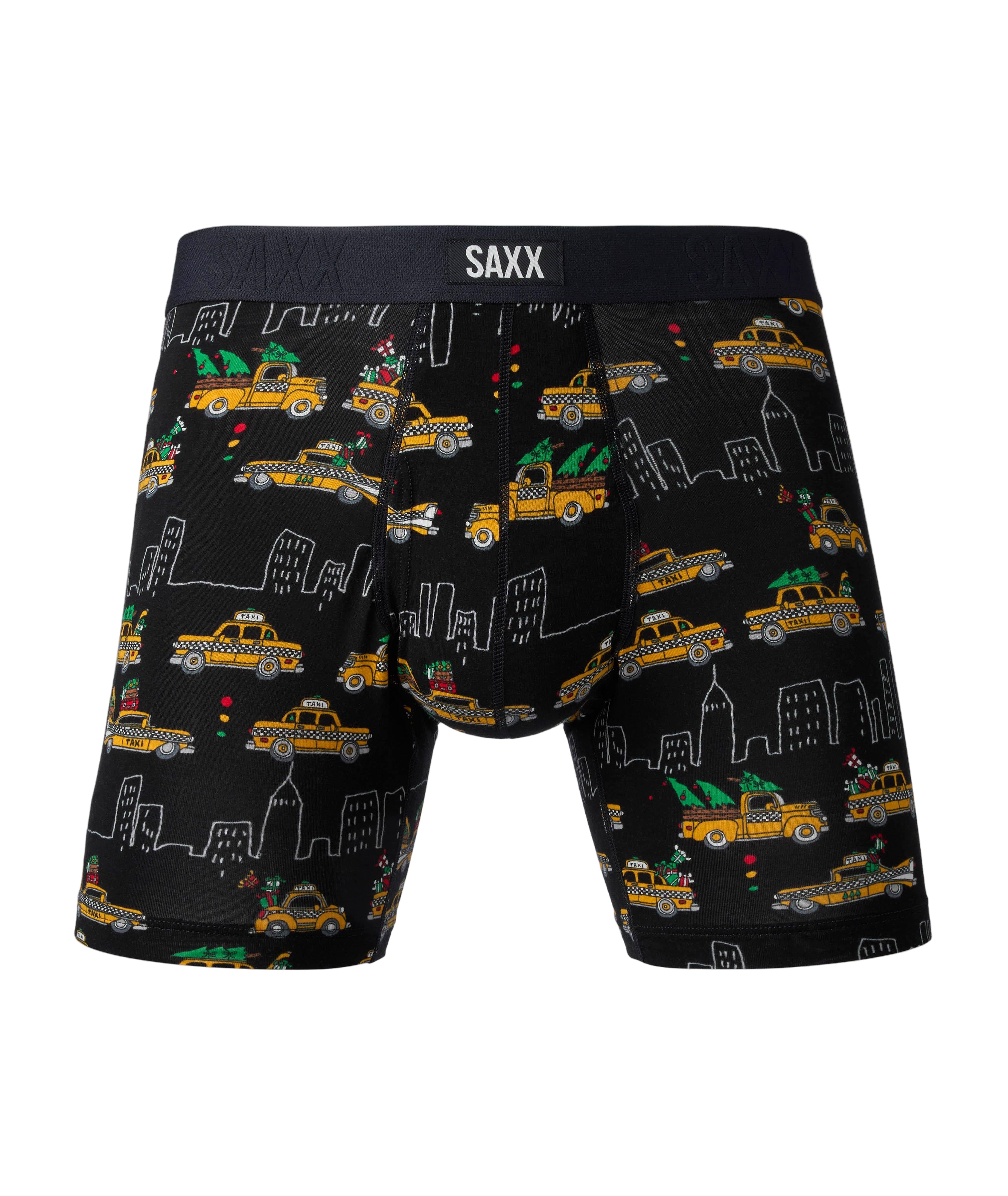 Black boxer briefs with taxi and cityscape pattern and SAXX branding on a gray background